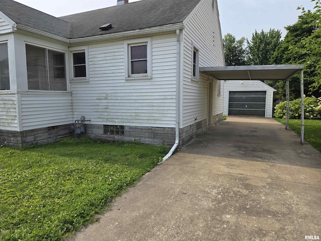 904 E Elm St, Canton, IL 61520 - view of side of property featuring concrete driveway, a chimney, roof with shingles, a garage, and an outdoor structure