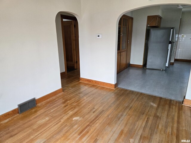 904 E Elm St, Canton, IL 61520 - unfurnished room featuring wood finished floors and arched walkways