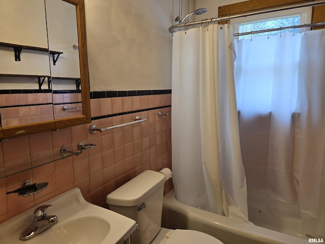 904 E Elm St, Canton, IL 61520 - bathroom featuring tile walls, shower / bath combination with curtain, and a wainscoted wall