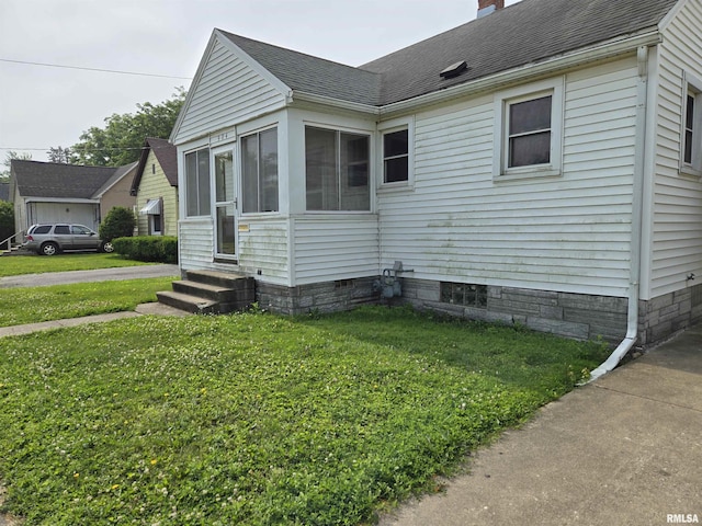 904 E Elm St, Canton, IL 61520 - view of side of home featuring entry steps, a shingled roof, a chimney, and a yard
