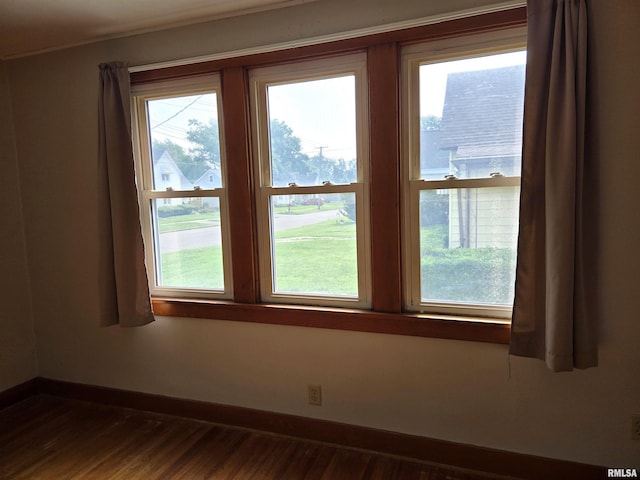 904 E Elm St, Canton, IL 61520 - unfurnished room featuring plenty of natural light and dark wood-style flooring