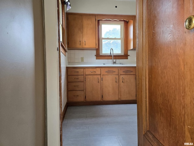 904 E Elm St, Canton, IL 61520 - kitchen with light countertops, decorative backsplash, and brown cabinets