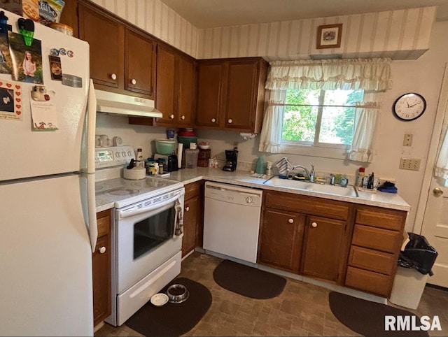218 W Kurlene Dr, Macomb, IL 61455 - kitchen with white appliances, under cabinet range hood, light countertops, and brown cabinets