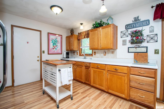 100 Oakridge Ct, Dahinda, IL 61428 - kitchen featuring light wood finished floors, light countertops, brown cabinets, and backsplash