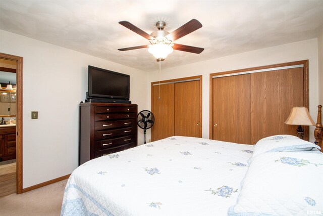 100 Oakridge Ct, Dahinda, IL 61428 - bedroom featuring two closets, light carpet, and ceiling fan