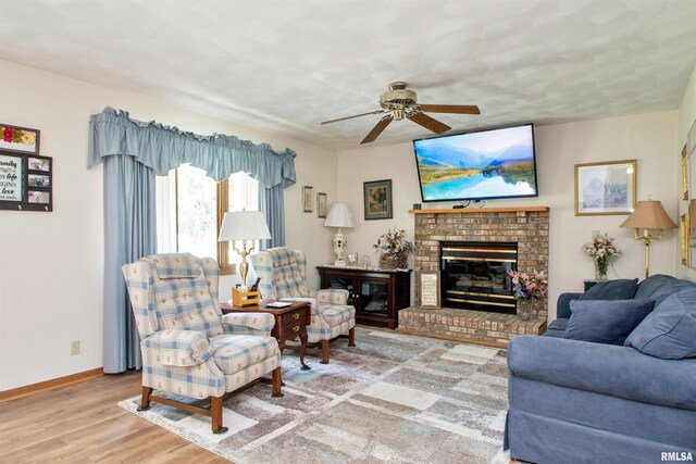 100 Oakridge Ct, Dahinda, IL 61428 - living area with a ceiling fan, wood finished floors, and a brick fireplace