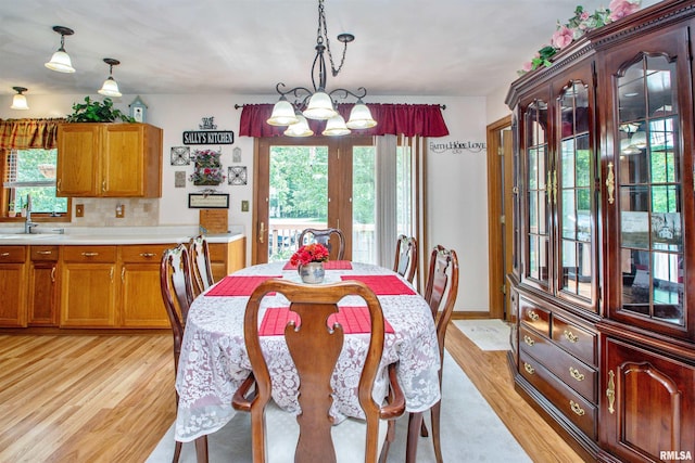 100 Oakridge Ct, Dahinda, IL 61428 - dining space featuring light wood-style floors, plenty of natural light, and a chandelier