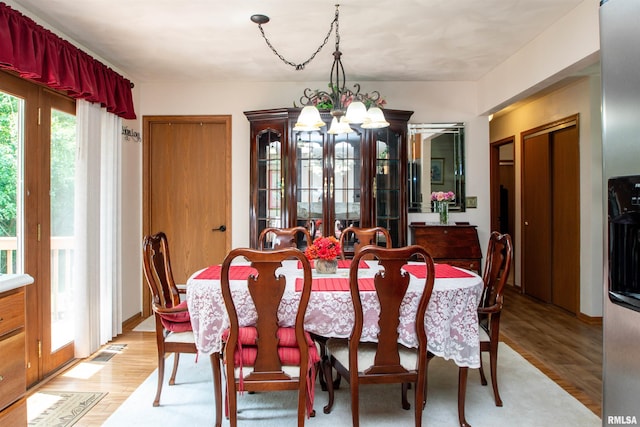 100 Oakridge Ct, Dahinda, IL 61428 - dining space featuring a chandelier and light wood-type flooring