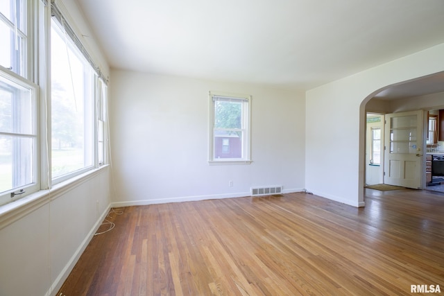 1030 E Euclid Ave, Peoria Heights, IL 61616 - empty room with arched walkways and light wood-style floors