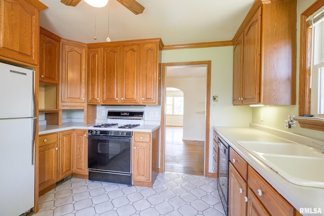 1030 E Euclid Ave, Peoria Heights, IL 61616 - kitchen featuring freestanding refrigerator, gas stove, a ceiling fan, light countertops, and arched walkways