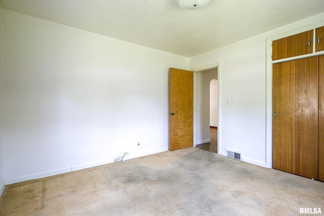 1030 E Euclid Ave, Peoria Heights, IL 61616 - unfurnished bedroom with arched walkways, carpet flooring, and a closet