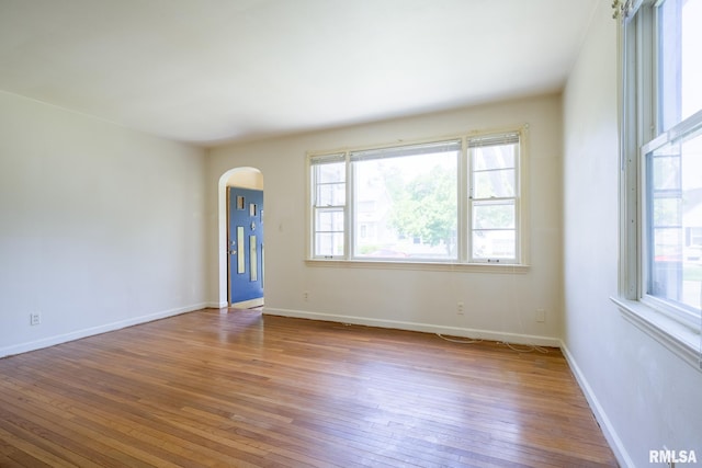 1030 E Euclid Ave, Peoria Heights, IL 61616 - unfurnished room with arched walkways and hardwood / wood-style floors