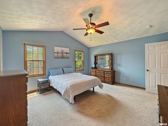 125 Prairieview Dr, East Peoria, IL 61611 - carpeted bedroom featuring multiple windows, vaulted ceiling, and a ceiling fan