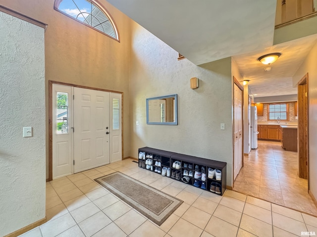 125 Prairieview Dr, East Peoria, IL 61611 - entryway with a textured wall and light tile patterned flooring