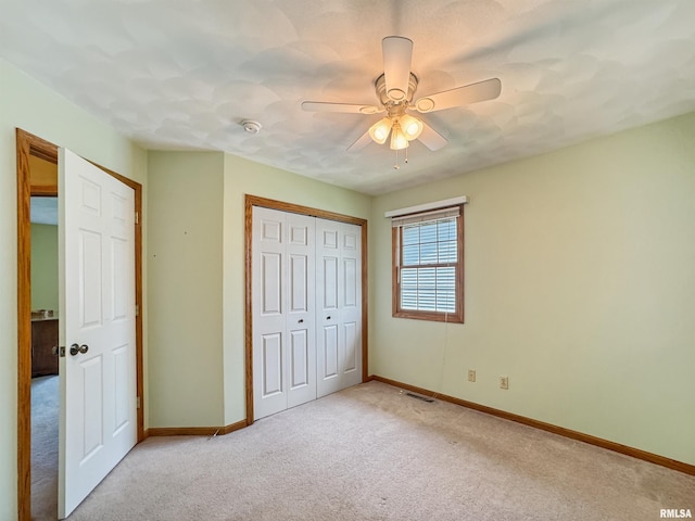 125 Prairieview Dr, East Peoria, IL 61611 - unfurnished bedroom featuring light colored carpet, a closet, and ceiling fan