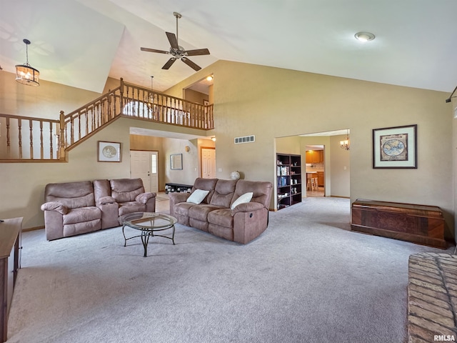 125 Prairieview Dr, East Peoria, IL 61611 - carpeted living room featuring ceiling fan, high vaulted ceiling, and a chandelier