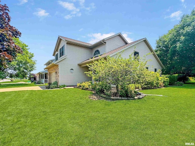 125 Prairieview Dr, East Peoria, IL 61611 - view of home's exterior with concrete driveway, a lawn, and an attached garage