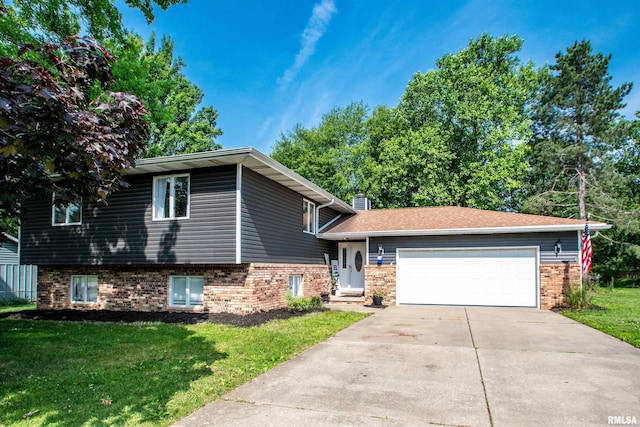324 Pinecrest Dr, Germantown Hills, IL 61548 - split level home featuring brick siding, a front yard, an attached garage, and driveway