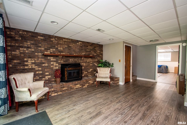 324 Pinecrest Dr, Germantown Hills, IL 61548 - unfurnished room with wood finished floors, a drop ceiling, and a fireplace