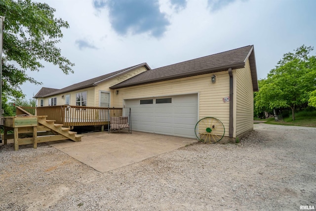 21501 N Berchtold Rd, Chillicothe, IL 61523 - view of home's exterior featuring a deck, an attached garage, and concrete driveway