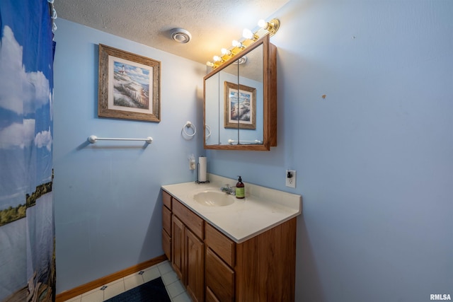 21501 N Berchtold Rd, Chillicothe, IL 61523 - bathroom featuring vanity, a textured ceiling, and tile patterned floors