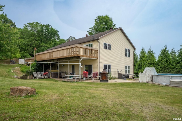 21501 N Berchtold Rd, Chillicothe, IL 61523 - rear view of property with a patio, a lawn, and an outdoor pool
