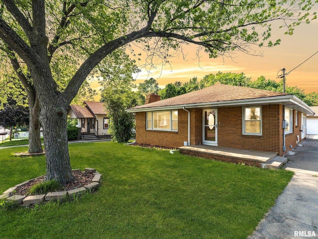 621 E Sciota Ave, Peoria Heights, IL 61616 - single story home featuring a chimney, a lawn, and brick siding