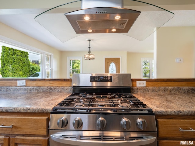 621 E Sciota Ave, Peoria Heights, IL 61616 - kitchen featuring stainless steel gas stove, brown cabinetry, healthy amount of natural light, and range hood
