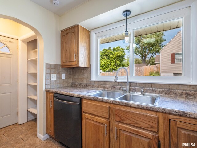 621 E Sciota Ave, Peoria Heights, IL 61616 - kitchen with dishwasher, brown cabinets, and hanging light fixtures