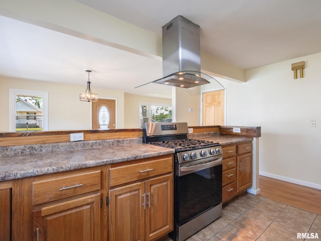 621 E Sciota Ave, Peoria Heights, IL 61616 - kitchen with gas stove, island exhaust hood, healthy amount of natural light, and brown cabinets