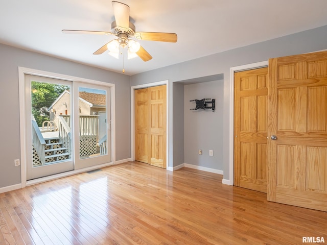 621 E Sciota Ave, Peoria Heights, IL 61616 - unfurnished bedroom featuring multiple closets, access to outside, wood finished floors, and ceiling fan