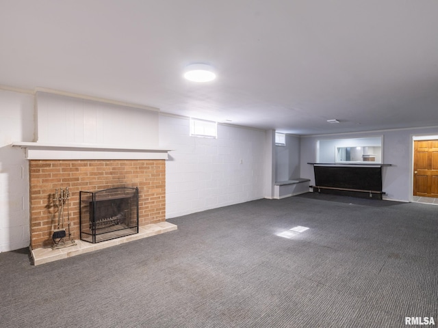 621 E Sciota Ave, Peoria Heights, IL 61616 - unfurnished living room with a brick fireplace, carpet floors, and concrete block wall