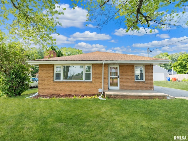 621 E Sciota Ave, Peoria Heights, IL 61616 - view of front facade featuring a front lawn, a chimney, brick siding, and driveway