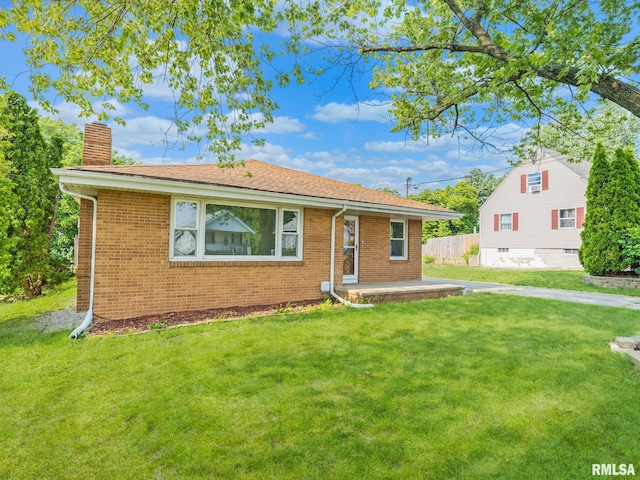 621 E Sciota Ave, Peoria Heights, IL 61616 - view of front facade featuring a chimney, brick siding, and a patio area