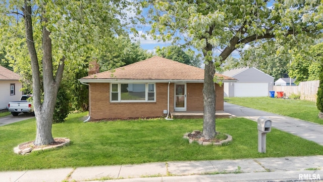 621 E Sciota Ave, Peoria Heights, IL 61616 - view of front of house featuring a chimney, brick siding, a detached garage, a shingled roof, and an outdoor structure
