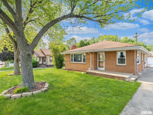 621 E Sciota Ave, Peoria Heights, IL 61616 - ranch-style house with a chimney, brick siding, and a front lawn