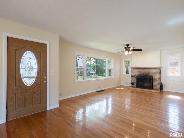 621 E Sciota Ave, Peoria Heights, IL 61616 - foyer featuring a ceiling fan, light wood-style floors, and a fireplace