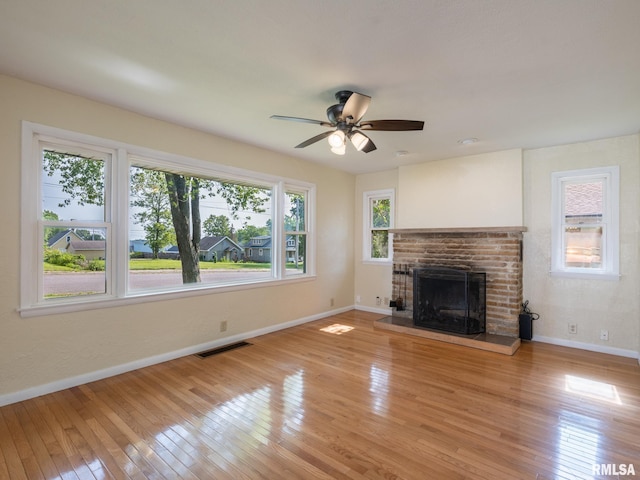 621 E Sciota Ave, Peoria Heights, IL 61616 - unfurnished living room featuring light wood finished floors, a fireplace, and ceiling fan