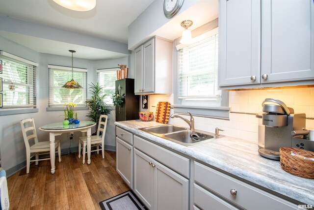 202 Esser St, Washington, IL 61571 - kitchen featuring decorative backsplash, healthy amount of natural light, light countertops, and dark wood-type flooring