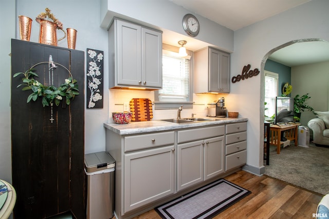 202 Esser St, Washington, IL 61571 - kitchen with arched walkways, wood finished floors, gray cabinets, and tasteful backsplash