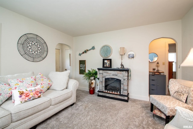 202 Esser St, Washington, IL 61571 - living area featuring carpet, arched walkways, and a stone fireplace