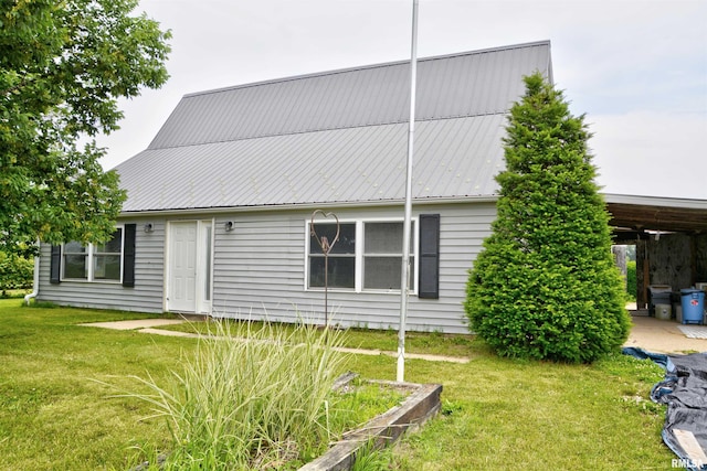 70 Constitution Rd, Colchester, IL 62326 - rear view of property with a lawn and a metal roof