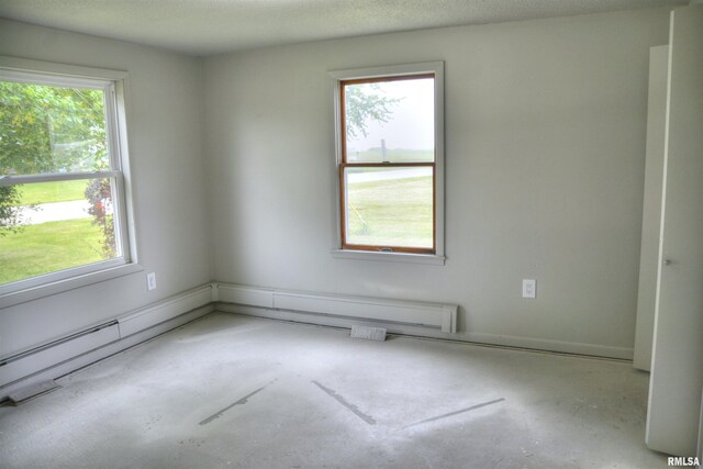 70 Constitution Rd, Colchester, IL 62326 - empty room with unfinished concrete floors and healthy amount of natural light