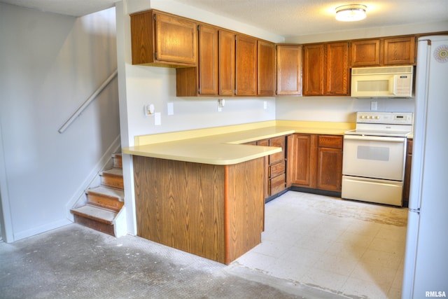 70 Constitution Rd, Colchester, IL 62326 - kitchen featuring white appliances, a peninsula, brown cabinetry, and light countertops