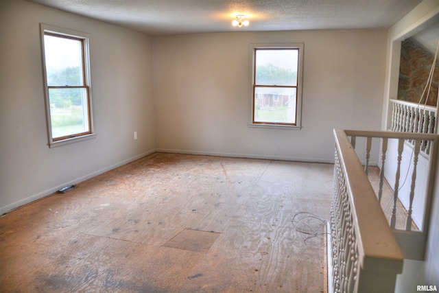 70 Constitution Rd, Colchester, IL 62326 - spare room with baseboards and a textured ceiling