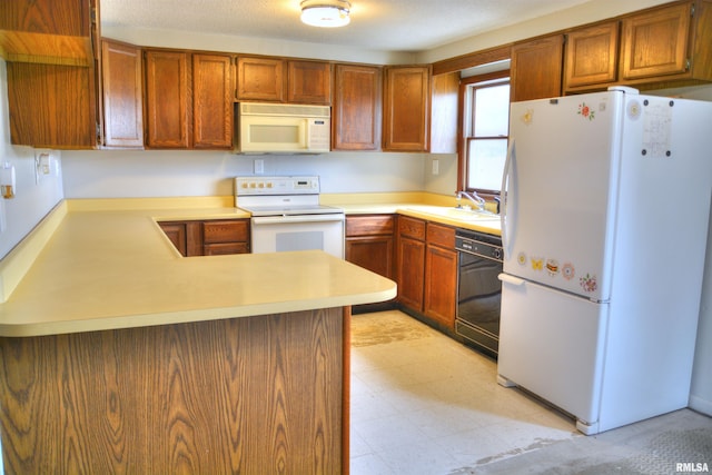 70 Constitution Rd, Colchester, IL 62326 - kitchen featuring white appliances, light countertops, a peninsula, light floors, and brown cabinets