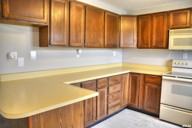 70 Constitution Rd, Colchester, IL 62326 - kitchen featuring white appliances, light countertops, and brown cabinetry
