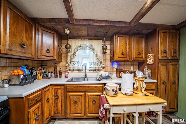 509 W Mcclure Ave, Peoria, IL 61604 - kitchen with decorative backsplash, brown cabinetry, light countertops, beam ceiling, and range