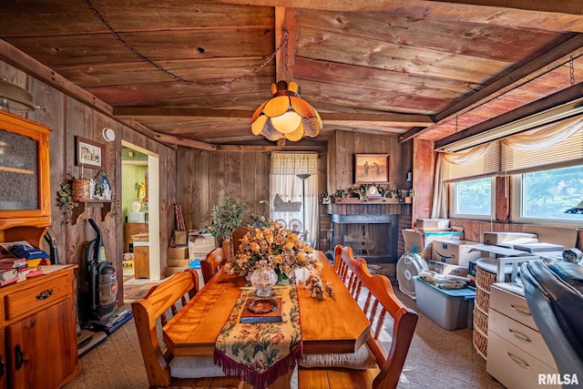 509 W Mcclure Ave, Peoria, IL 61604 - dining room with wood ceiling, carpet floors, a brick fireplace, and wooden walls