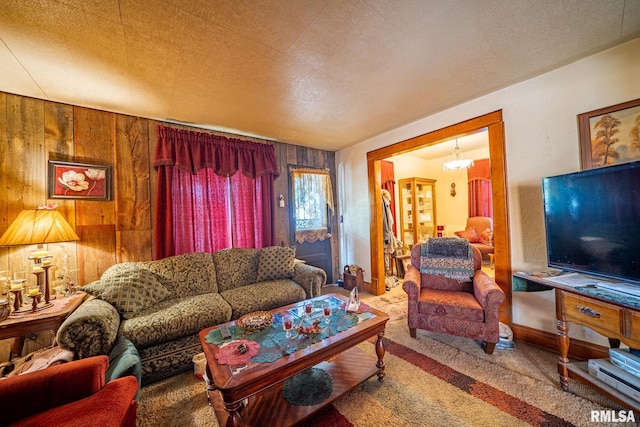 509 W Mcclure Ave, Peoria, IL 61604 - carpeted living area with wood walls and a textured ceiling